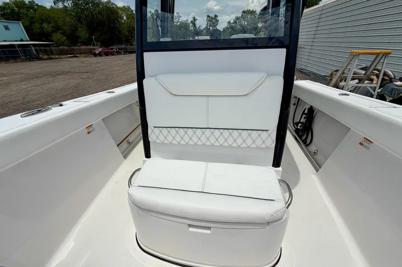 Slide: The Image of 2023 Sportsman Heritage 261 Center Console boat seating area with white cushioned seats. - 32
