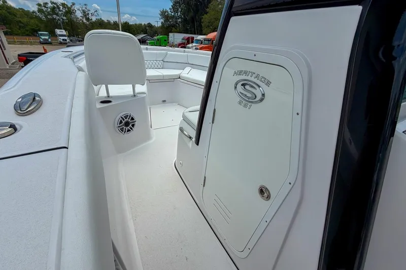 Slide: The Image of Interior of 2023 Sportsman Heritage 261 Center Console boat, featuring a compact marine toilet. - 39