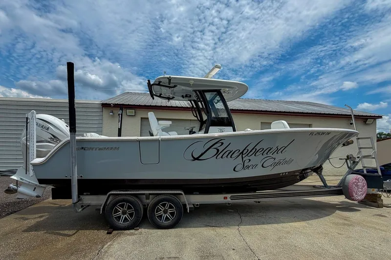 Slide: The Image of 2023 Sportsman Heritage 261 Center Console boat on trailer, named "Blackbeard Soca Captain." - 48