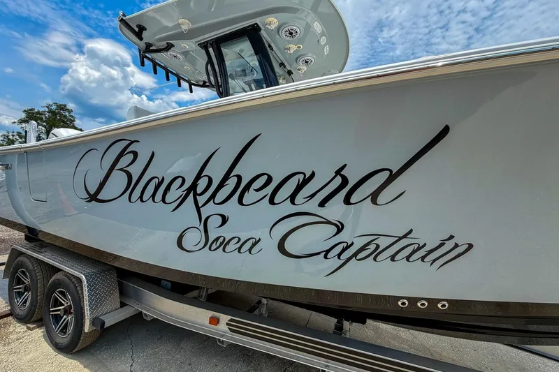 Slide: The Image of 2023 Sportsman Heritage 261 Center Console boat with "Blackbeard Soca Captain" text on the side. - 50
