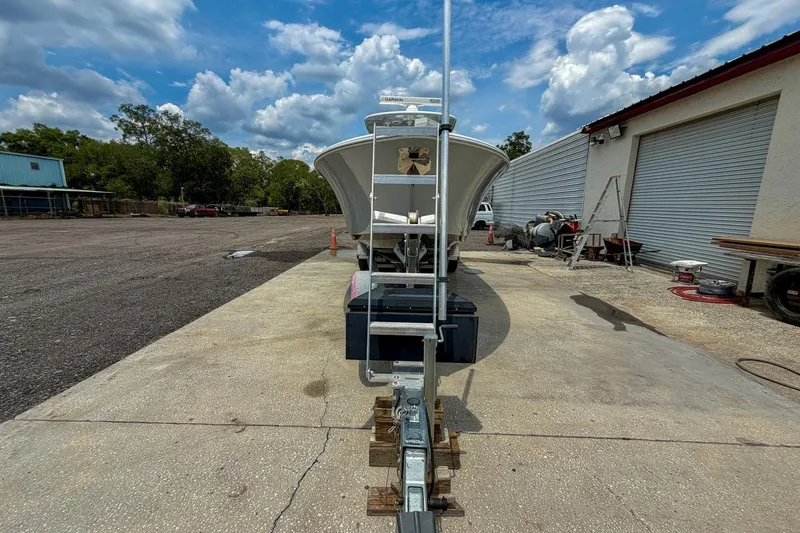 Slide: The Image of 2023 Sportsman Heritage 261 Center Console boat on trailer under cloudy sky. - 52
