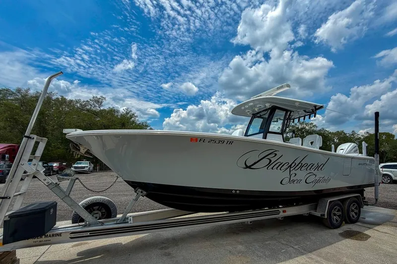 Slide: The Image of 2023 Sportsman Heritage 261 Center Console boat on trailer under a blue sky. - 54