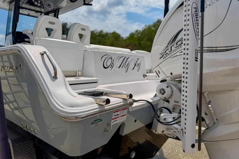 Slide: The Image of 2023 Sportsman Heritage 261 Center Console boat transom with hydraulic components and Florida license plate. - 58
