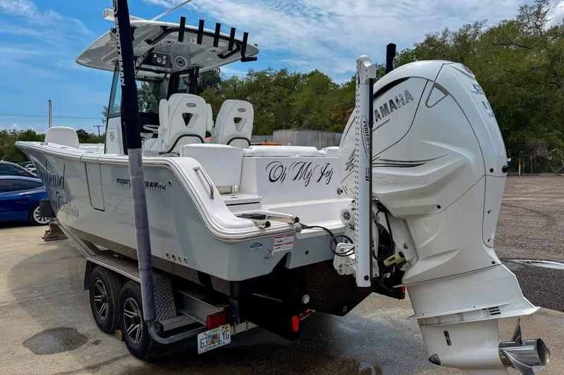 Slide: The Image of 2023 Sportsman Heritage 261 Center Console boat with powerful 425 V8 engine, docked outdoors. - 64
