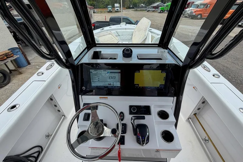 Slide: The Image of 2023 Sportsman Heritage 261 Center Console dashboard with steering wheel and navigation display. - 7