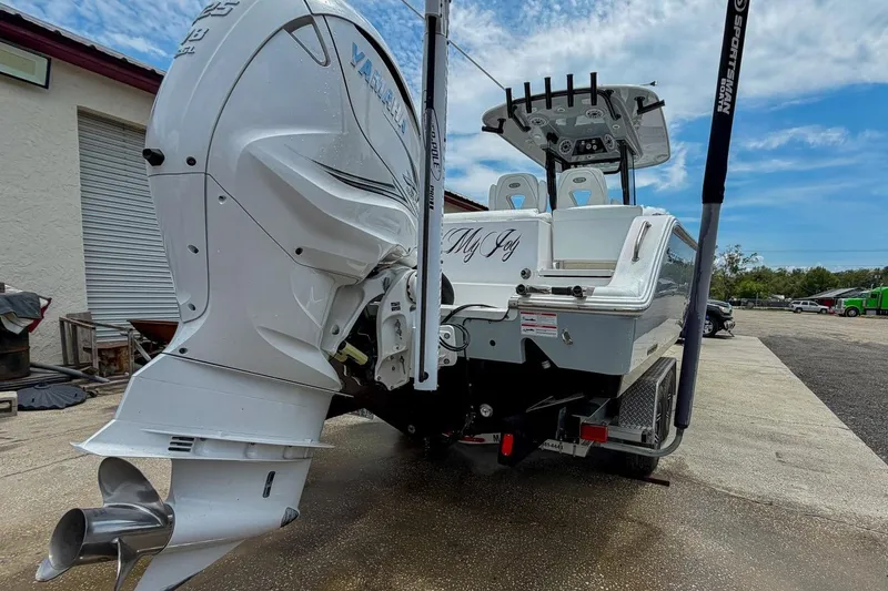 Slide: The Image of 2023 Sportsman Heritage 261 Center Console boat on trailer, detailed view of hull and motor. - 70