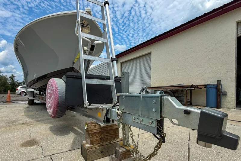 Slide: The Image of 2023 Sportsman Heritage 261 Center Console boat on trailer, parked outdoors. - 73