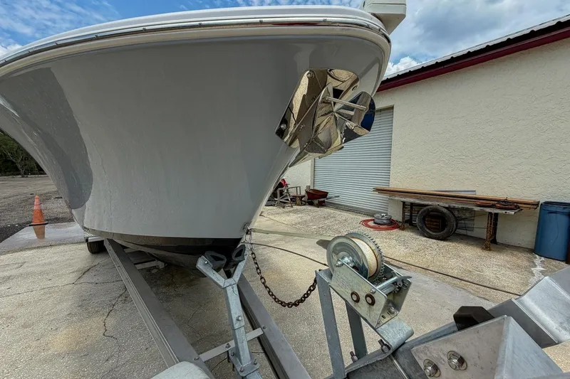 Slide: The Image of Close-up of a 2023 Sportsman Heritage 261 Center Console boat trailer winch. - 74