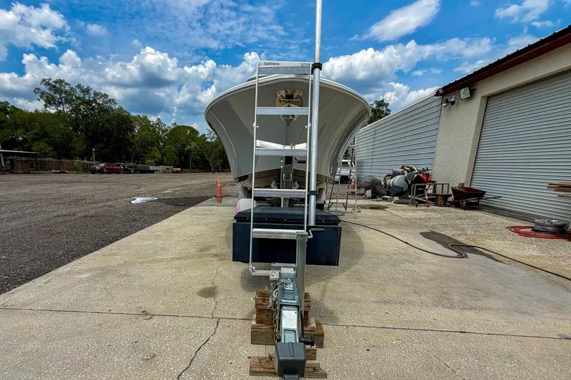 Slide: The Image of 2023 Sportsman Heritage 261 Center Console boat on trailer under a cloudy sky. - 77