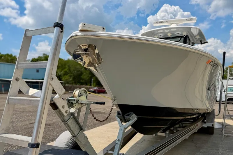 Slide: The Image of 2023 Sportsman Heritage 261 Center Console boat on trailer, under a clear blue sky. - 78
