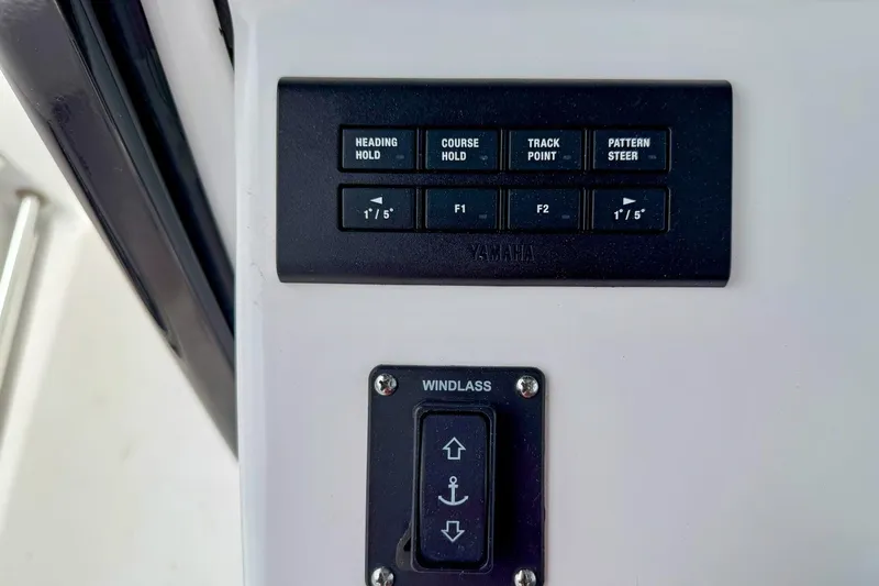 Slide: The Image of Control panel of 2023 Sportsman Heritage 261 Center Console boat with throttle and switches. - 9