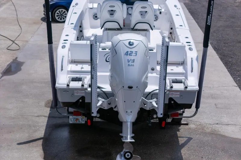 Slide: The Image of 2023 Sportsman Heritage 261 Center Console boat, white interior, dual seats, modern dashboard. - 93