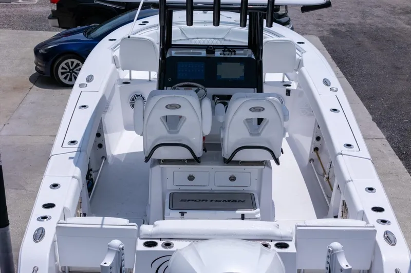 Slide: The Image of 2023 Sportsman Heritage 261 Center Console boat on trailer, parked near a building. - 95