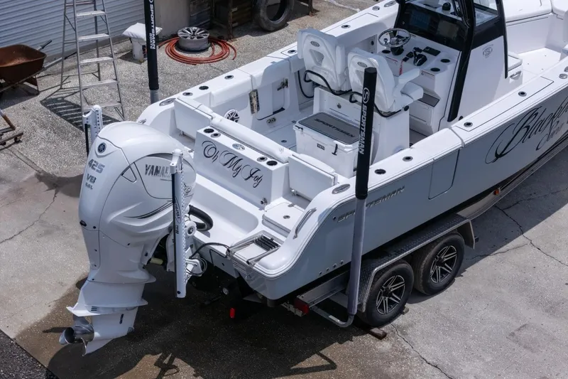 Slide: The Image of 2023 Sportsman Heritage 261 Center Console boat on trailer, parked outside a garage. - 96