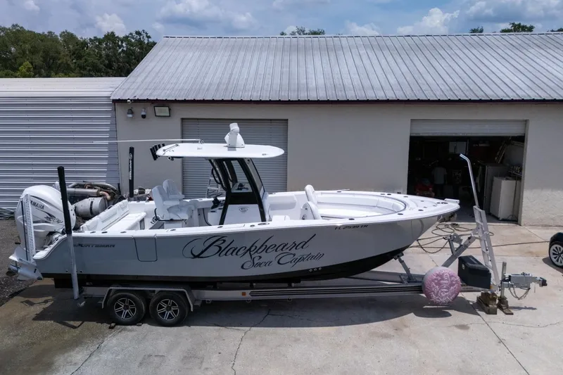 Slide: The Image of 2023 Sportsman Heritage 261 Center Console boat, aerial view on concrete surface. - 98