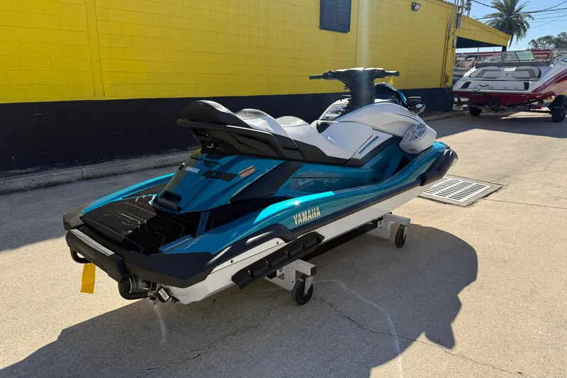 Slide: The Image of 2026 Yamaha WaveRunner FX Cruiser HO in teal, parked outdoors on a sunny day. - 10