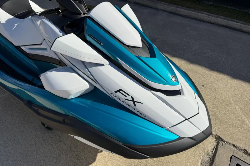Slide: The Image of 2026 Yamaha WaveRunner FX Cruiser HO in sleek blue and white design on pavement. - 12