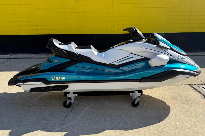 Slide: The Image of 2026 Yamaha WaveRunner FX Cruiser HO in teal and white, parked on concrete. - 3