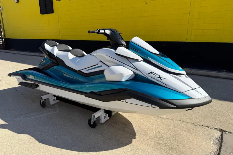 Slide: The Image of 2026 Yamaha WaveRunner FX Cruiser HO in blue and white, parked outdoors. - 4