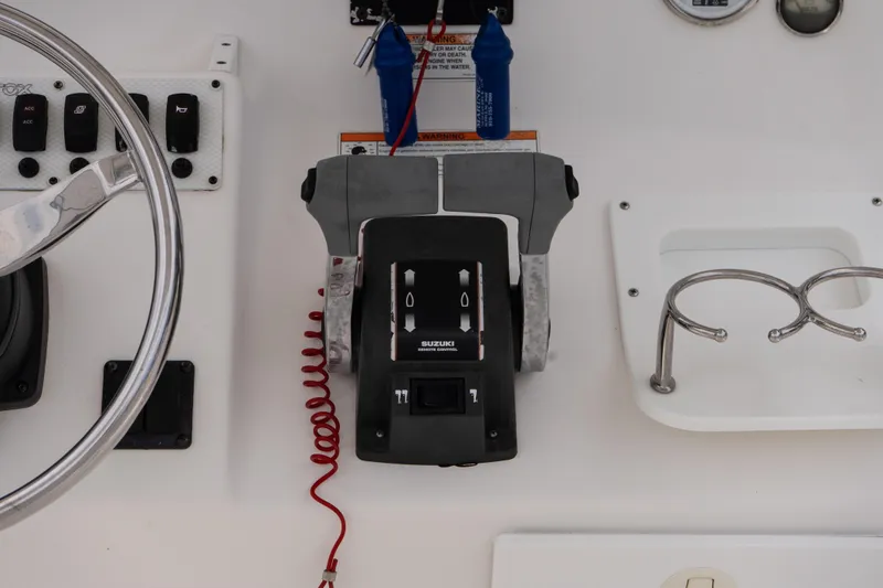 Slide: The Image of Control panel of a 2010 Sea Fox 256 Center Console boat with steering wheel and throttle. - 12