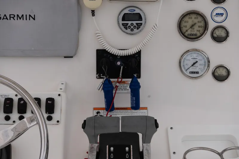 Slide: The Image of Control panel of a 2010 Sea Fox 256 Center Console boat with gauges and switches. - 13