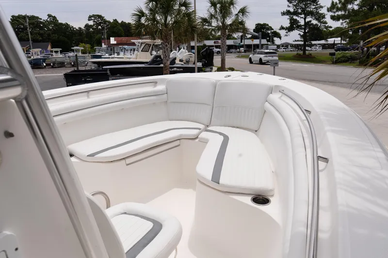 Slide: The Image of 2010 Sea Fox 256 Center Console boat with white seating and palm trees in the background. - 15