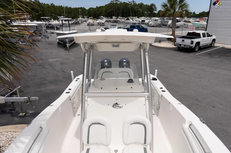 Slide: The Image of 2010 Sea Fox 256 Center Console boat in a marina with trailers and vehicles. - 17