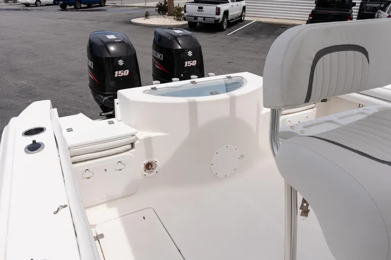 Slide: The Image of 2010 Sea Fox 256 Center Console boat with dual Suzuki 150 engines, featuring a spacious deck. - 19
