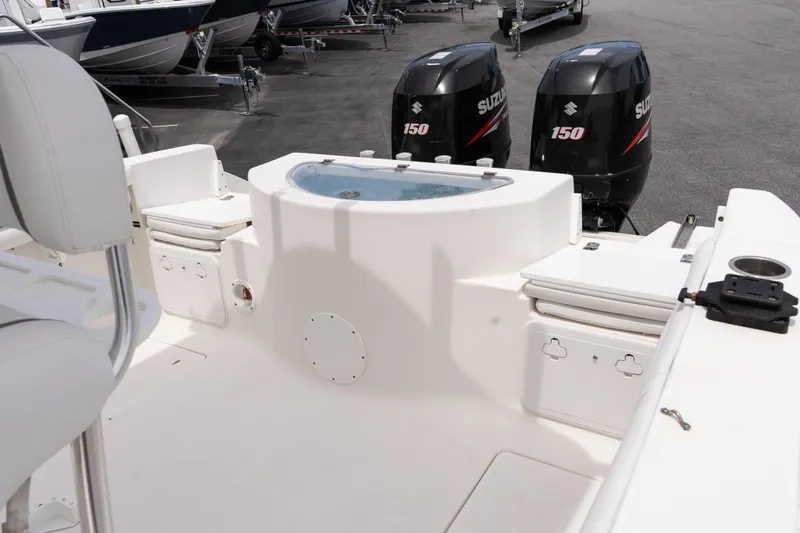 Slide: The Image of 2010 Sea Fox 256 Center Console boat with dual Suzuki 150 engines, featuring spacious deck layout. - 20