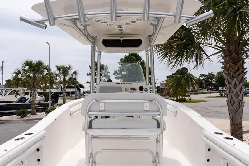 Slide: The Image of 2010 Sea Fox 256 Center Console boat with T-top, parked near palm trees. - 7