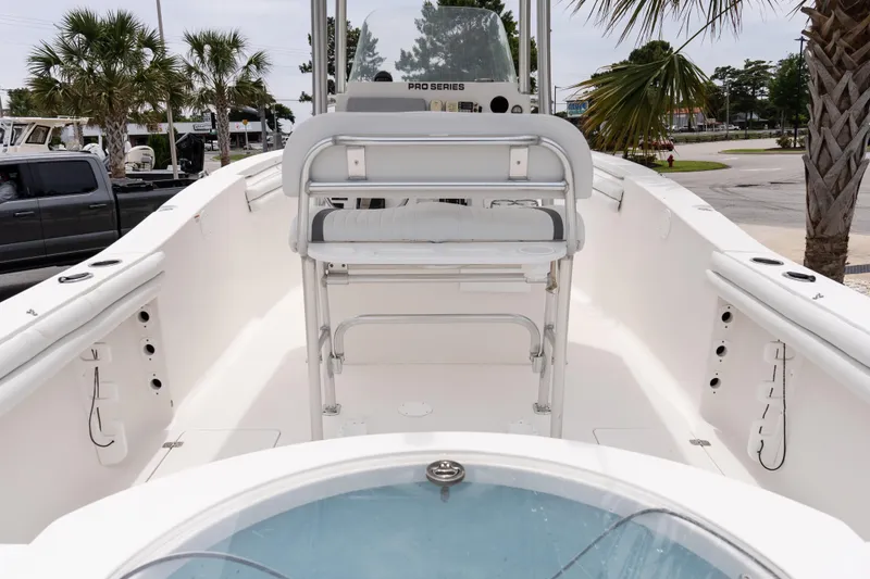 Slide: The Image of 2010 Sea Fox 256 Center Console boat interior with seating and palm trees in the background. - 8