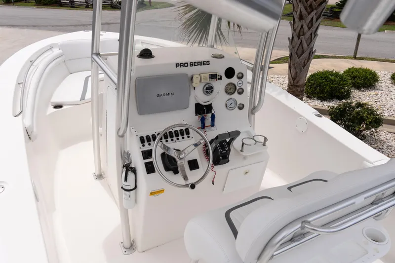 Slide: The Image of 2010 Sea Fox 256 Center Console boat interior with steering wheel and Garmin navigation system. - 9