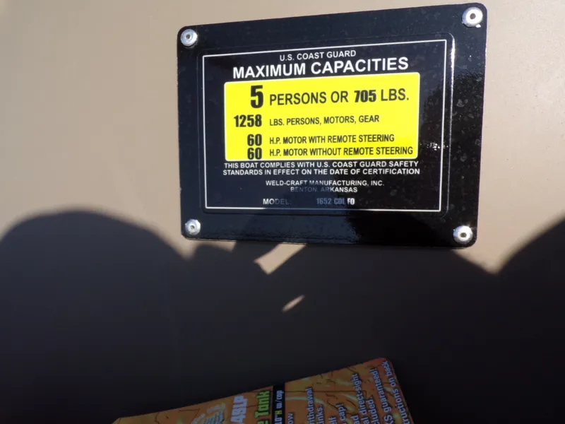 Slide: The Image of Weldcraft 1652 CDL FO 2026 boat capacity plate, maximum persons and weight limit. - 18