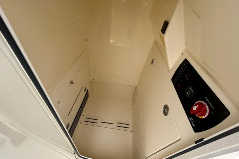 Slide: The Image of Interior view of 2026 Scout 220 XSF boat's control panel and storage area. - 11