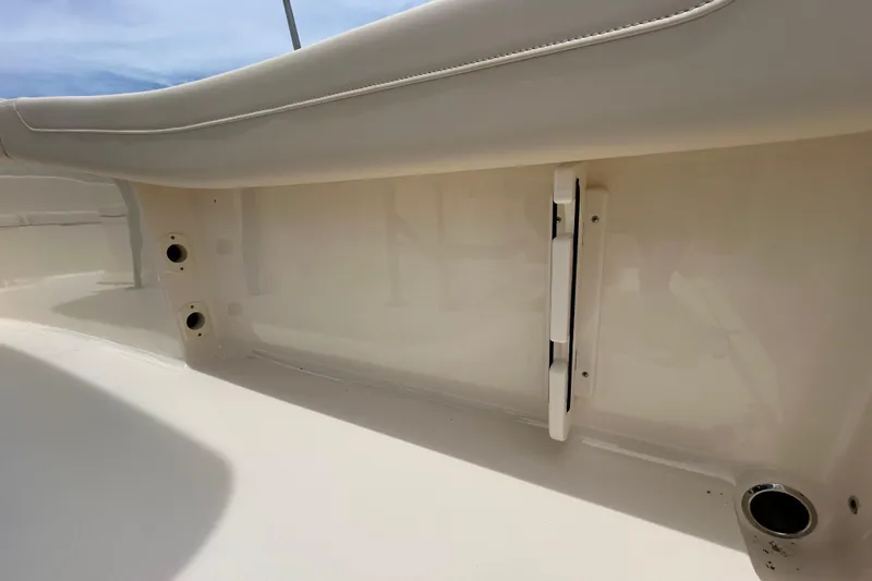 Slide: The Image of 2026 Scout 220 XSF boat interior detail, featuring sleek white seating and storage compartments. - 13