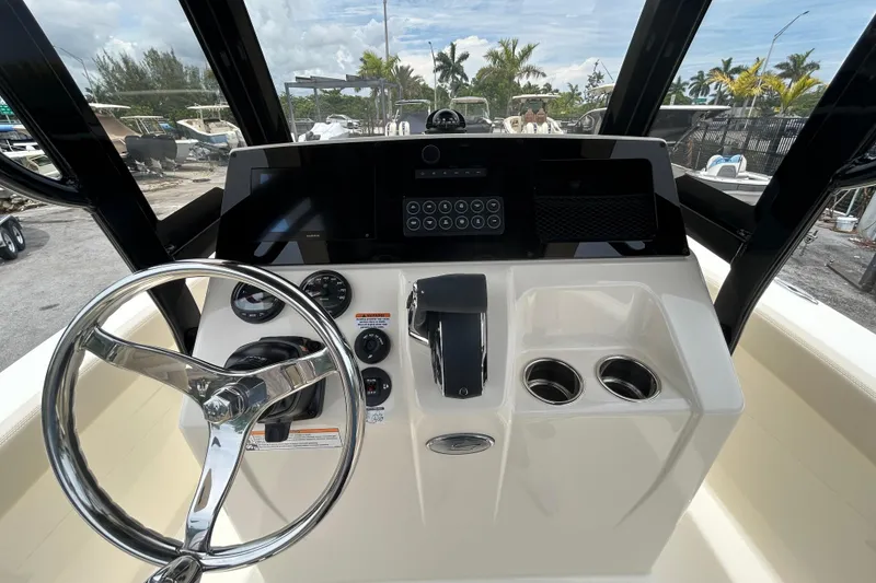 Slide: The Image of 2026 Scout 220 XSF boat dashboard with steering wheel and control panel. - 2