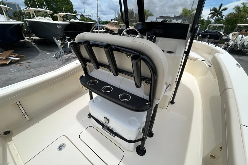 Slide: The Image of 2026 Scout 220 XSF boat interior with rod holders and cooler, showcasing sleek design. - 4
