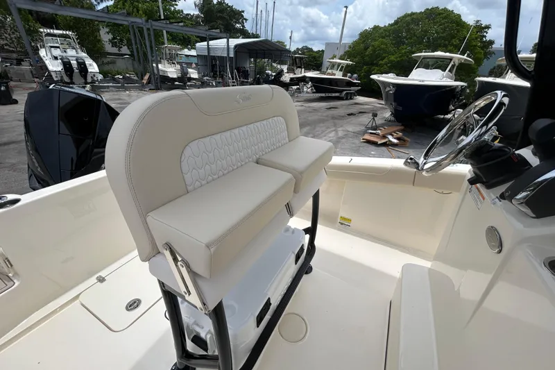 Slide: The Image of 2026 Scout 220 XSF boat interior with beige seating and steering wheel. - 5