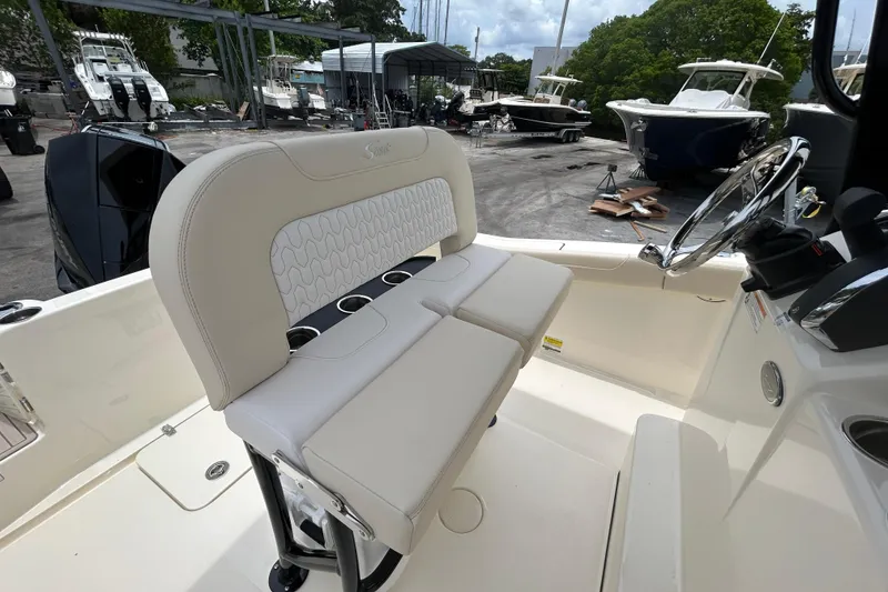 Slide: The Image of 2026 Scout 220 XSF boat interior with cushioned seating and steering wheel. - 6