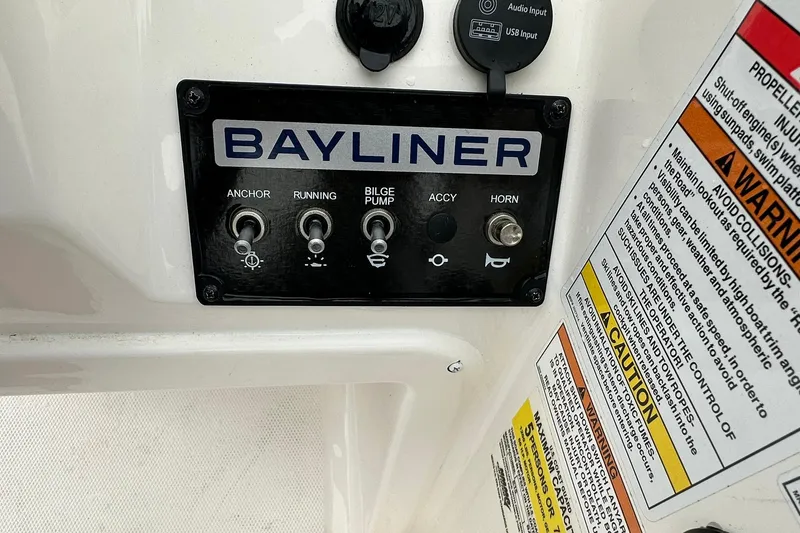 Slide: The Image of Control panel of 2024 Bayliner Element M15 boat with switches and safety warnings. - 11
