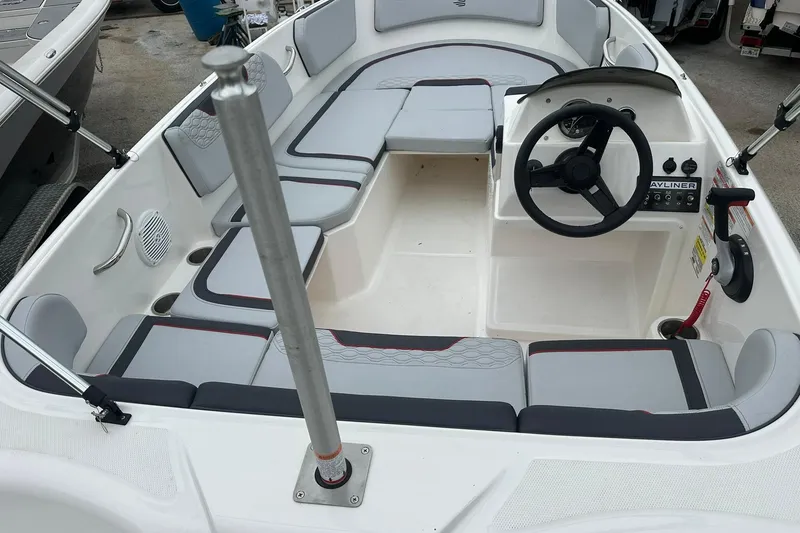 Slide: The Image of 2024 Bayliner Element M15 boat interior with seating and steering wheel. - 13