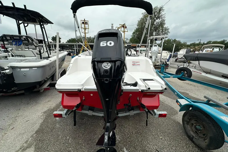 Slide: The Image of 2024 Bayliner Element M15 boat with 60 HP engine on trailer. - 15