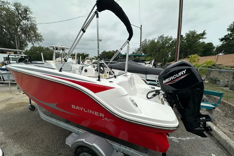 Slide: The Image of 2024 Bayliner Element M15 boat with Mercury engine, parked outdoors. - 16