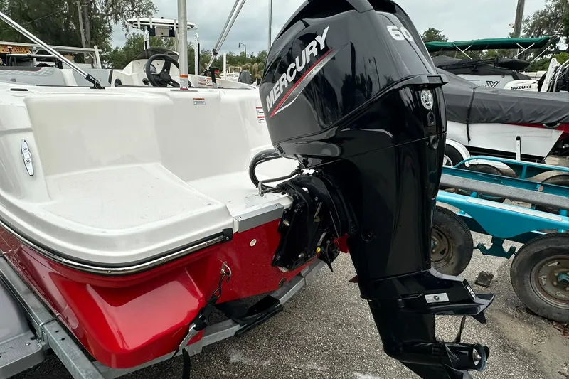 Slide: The Image of 2024 Bayliner Element M15 boat with Mercury 60 outboard motor, red and white design. - 18