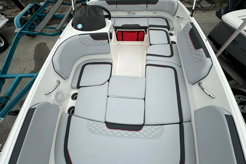 Slide: The Image of 2024 Bayliner Element M15 boat interior with gray seating and red accents. - 5