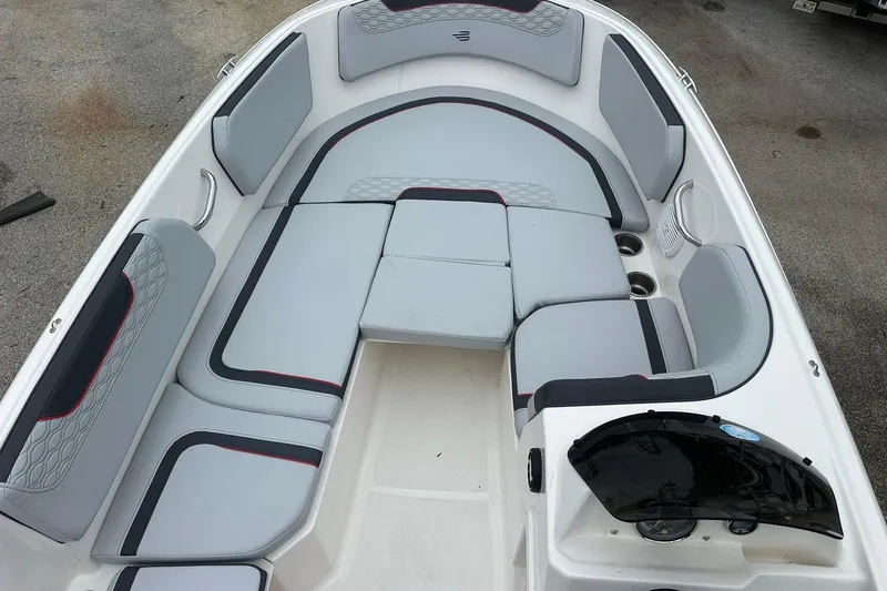 Slide: The Image of 2024 Bayliner Element M15 boat interior with gray cushioned seating and cup holders. - 9