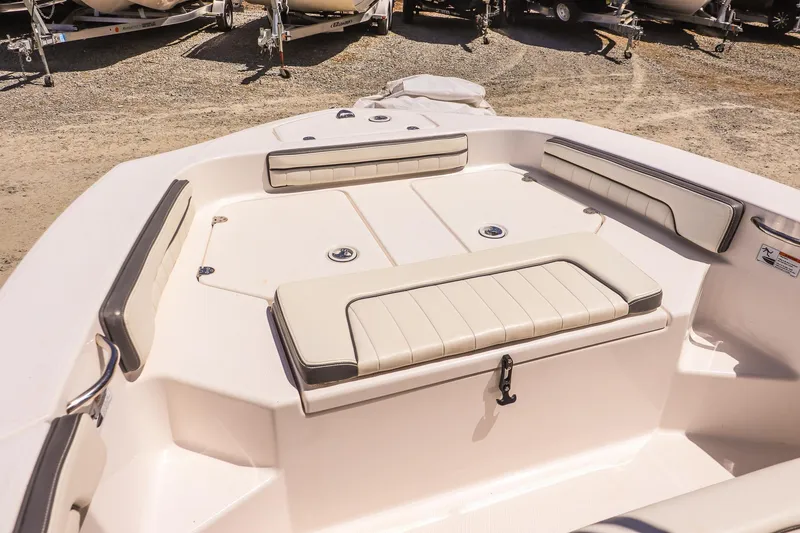 Slide: The Image of 2017 Yamaha Boats 190 FSH Sport interior with cushioned seating and storage compartments. - 10