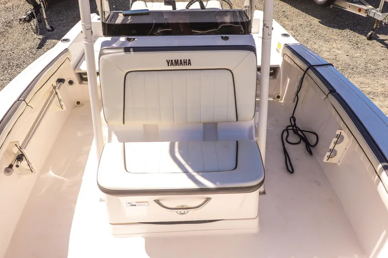 Slide: The Image of 2017 Yamaha Boats 190 FSH Sport interior with white seating and storage. - 11