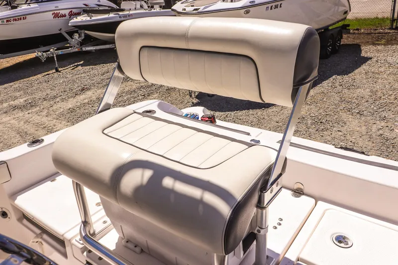 Slide: The Image of 2017 Yamaha Boats 190 FSH Sport seating, featuring sleek white upholstery and sturdy metal supports. - 13