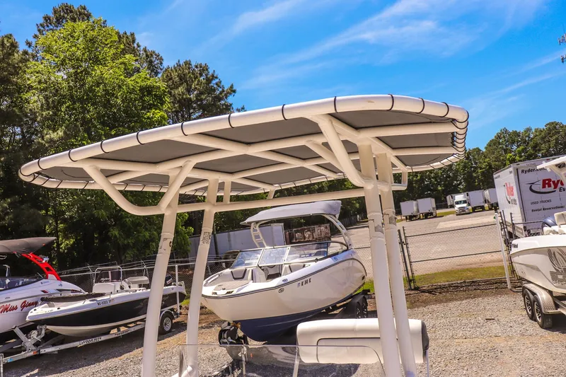 Slide: The Image of 2017 Yamaha Boats 190 FSH Sport with T-top in a sunny outdoor setting. - 14